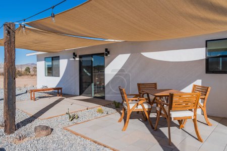 Photo for Backyard patio dining set with protective sun shade canopy at a desert home - Royalty Free Image