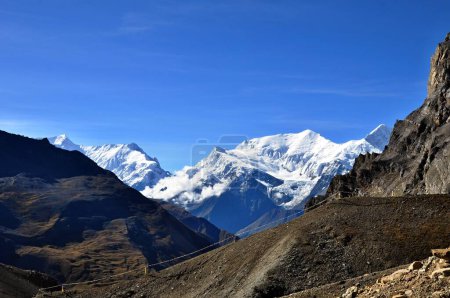 Photo for View of Himalaya mountains covered with snow with blue sky in the background. Annapurna Circuit Trek. Thorong La Pass. Thorong Pedi. Nepal, Asia. - Royalty Free Image