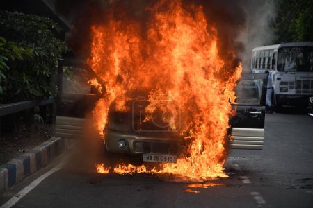 Photo for May 31, 2023, Kolkata, India. A running mid-size sport utility vehicle (SUV) catches accidental fire due to overheat on the busy AJC Bose Road. No death or injury suffered in the accident, on May 31, 2023, in Kolkata City, India - Royalty Free Image