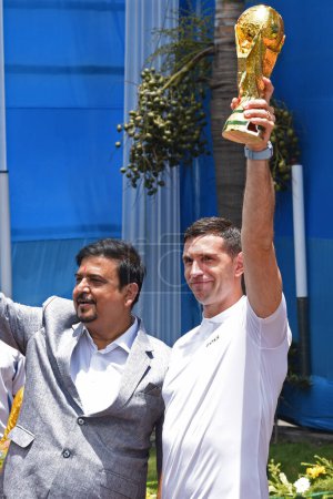 Photo for July 05,2023, Kolkata, India: 2022 FIFA World Cup winning, Argentina's  goalkeeper Emiliano Martinez, holds a World Cup trophy replica during a parade of the main streets of the city - Royalty Free Image