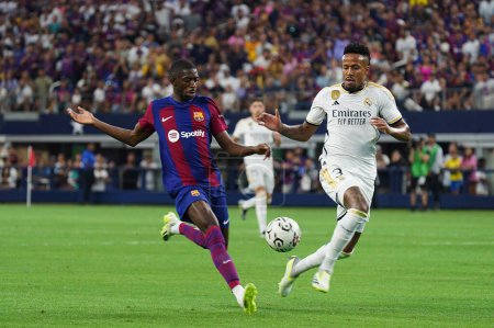 Photo for July 29, 2023, Arlington, Texas, United States: Barcelona's Ousmane Dembele in action against Real Madrid's Eder Militao during the Soccer Champions Tour game between Barcelona and Real Madrid played at AT&T Stadium - Royalty Free Image