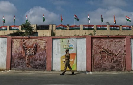 Photo for August 15,2023, Srinagar Kashmir, India :  An Indian policeman walks outside the Bakshi Stadium venue of India's 77th Independence Day celebrations in Srinagar - Royalty Free Image