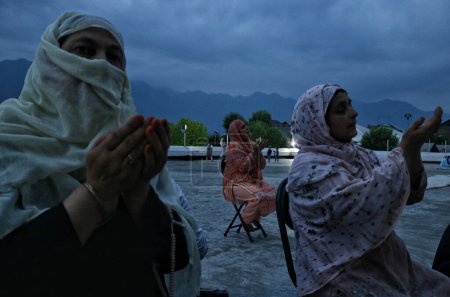 Photo for July 16,2023, Srinagar Kashmir, India : Kashmiri Muslim women pray as they wait for the head priest to display a relic believed to be a hair from the beard of the Prophet Mohammad (PBUH) - Royalty Free Image