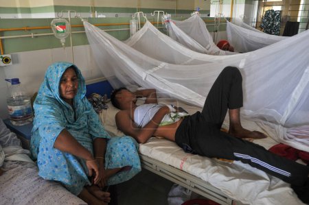 Téléchargez les photos : 26 juillet 2023 Sylhet-Bangladesh : Une mère est assise à côté de son fils infecté par la dengue au coin de la dengue de Sylhet MAG Osmani Medical College & Hospital, Sylhet, Bangladesh. Plus de 20 patients sont désormais admis au Coin de la Dengue - en image libre de droit