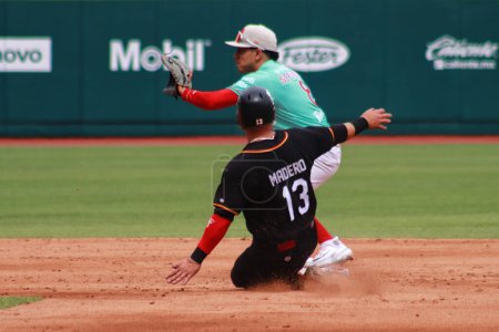 Photo for May 20, 2023 in Mexico City, Mexico: Diego Madero #13 of Piratas de Campeche sweeps to second base against Carlos Sepulveda #8 of Diablos Rojos del Mexico during the  match between the Piratas of Campeche and the Diablos Rojos del Mexico - Royalty Free Image