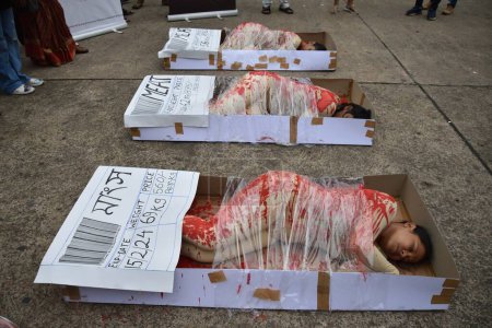 Photo for August 15, 2023, Kolkata, India. Animal lover activists hold a protest demonstration with symbolic human flesh in trays, a poignant visual representation of animals subjected to horrors of factory farming and posters against animal exploitation - Royalty Free Image