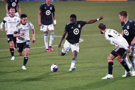 Photo for Saturday February 25, 2023, Frisco, USA:  Minnesota United forward Bongokuhle Hlongwane kicks the ball between FC Dallas players Alan Velsaco (20) and Facundo Quignon (5) during action in the second half at Toyota Stadium - Royalty Free Image