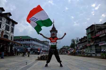 Photo for August 15,2023, Srinagar Kashmir, India : A supporter of Akhil Bharatiya Vidyarthi Parishad (ABVP) waves India's national flag during India's 77th Independence Day celebrations in Srinagar - Royalty Free Image