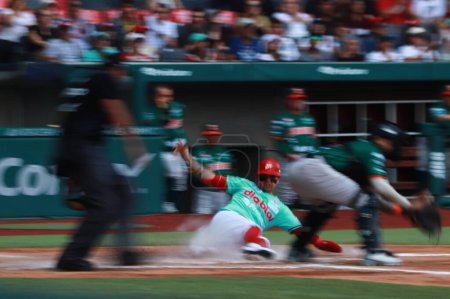 Photo for June 10, 2023 in Mexico City, Mexico: Juan Carlos Gamboa #47 of Red Devils of Mexico sweeps home during the mexican baseball league match  between the Yucatan Lions and the Mexico Red Devils at the Alfredo Harp Helu stadium - Royalty Free Image
