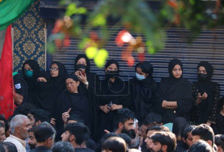 Photo for July 29,2023, Srinagar Kashmir, India : Shiite women mourners watch an Ashura procession from a house on 10th of Muharram, the first month of Islamic Calendar, in Srinagar - Royalty Free Image