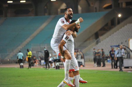 Photo for TUNIS, TUNISIA - SEPTEMBER 3: Yessine Meriah (04) and Dylan Bronn (06)  of Tunisia team celebrating after the goal  during a match of  the 2022 World Cup Qualifiers, between  Tunisia  and  Equatorial Guinea at Rades Olympic Stadium - Royalty Free Image