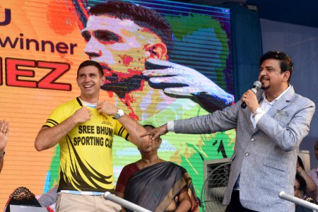 Photo for July 05,2023, Kolkata, India: 2022 FIFA World Cup winning, Argentina's  goalkeeper Emiliano Martinez, he puts the jersey of  Sree Bhumi Sporting Club during a fan event as part of his visit to India - Royalty Free Image