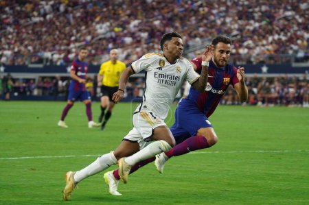 Photo for July 29, 2023, Arlington, Texas, United States: Real Madrid's Rodrygo and Barcelona's Eric Garcia chase after the ball during the Soccer Champions Tour game between Barcelona and Real Madrid played at AT&T Stadium - Royalty Free Image