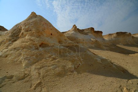 Photo for The Zekreet Peninsula  is a popular destination for foreign tourists due to its  limestone rock formations. The limestone escarpment featuring cliffs, pillars, and rocks - Royalty Free Image
