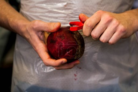 Photo for A person peeling a beetroot - Royalty Free Image