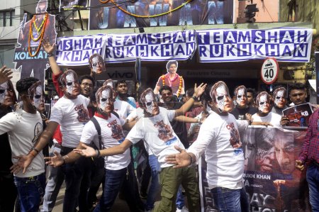 Foto de 7 de septiembre de 2023, Kolkata, India: Fans of actor Shah Rukh Khan hold a rally in his support wearing cardboard masks of the character Raj Vardhan Thakur played by Shah Rukh Khan in the movie "Jawan" outside the cinema where the movie is being shown - Imagen libre de derechos