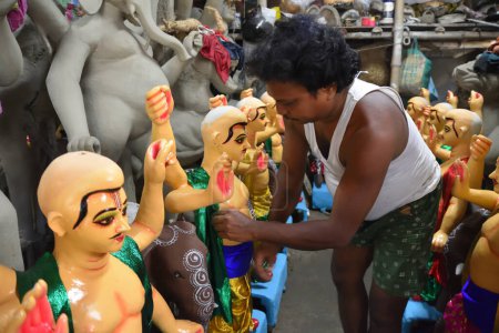 Photo for Howrah, India -13th September, 2023: Clay idols of God Vishwakarma are under making ahead of the annual one day Vishwakarma puja, which scheduled on 18th September, 2023. God Vishwakarma is considered as architect of  gods in Hindu mythology - Royalty Free Image