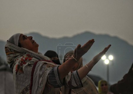 Photo for Srinagar Kashmir, India - September 29,2023: A Kashmiri Muslim woman prays before the head cleric  displays holy relic on occasion of s or Prophet Muhammad birth anniversary in Dargah Hazratbal shrine in Srinagar - Royalty Free Image