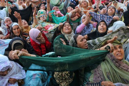 Photo for Srinagar Kashmir, India - September 29,2023: A Kashmiri Muslim women react as head cleric displays holy relic on occasion of Mawlid-un-Nabi or Prophet Muhammad birth anniversary in Dargah Hazratbal shrine in Srinagar - Royalty Free Image