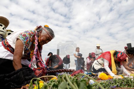 Photo for October 19, 2023, Mexico City, Mexico: People preside over the pre-Hispanic blessing ceremony of the Cempoalxochitl flower in the cempasuchil flower fields within the framework of the Day of the Dead festivity in the ejido in San Gregorio Atlapulco - Royalty Free Image