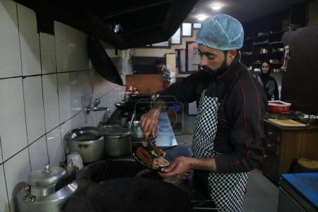 Photo for October 20,2023, Srinagar Kashmir, India : A chef is seen cooks a Kashmiri traditional food  know as  Kabab  as part of the  International Chefs Day in Srinagar at Tao Cafe Restaurant - Royalty Free Image