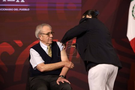 Photo for October 24, 2023, Mexico City, Mexico: Mexican Health Secretary Jorge Alcocer is vaccinated against influenza and Covid during the daily morning conference of the President of Mexico, Andres Manuel Lopez Obrador at the National Palace in Mexico City. - Royalty Free Image