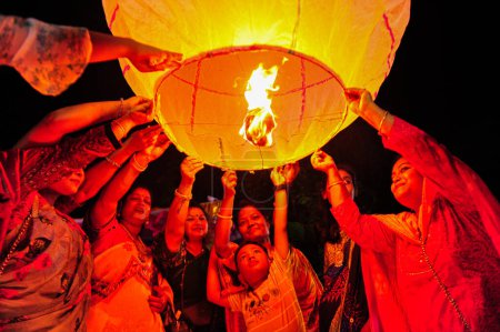 Photo for 28 October 2023 Sylhet, Bangladesh: Buddhists religious followers are lighting fire lanterns to celebrate yearly Prabarana Purnima 2023 at the Buddhist temples in Sylhet, Bangladesh - Royalty Free Image