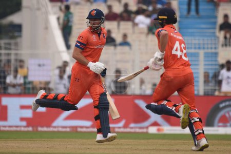 Photo for October 28, 2023, Kolkata, India : Colin Ackermann and Wesley Barresi take a run against Bangladesh during the match between Netherlands and Bangladesh of  the 2023 ICC Men's Cricket World Cup at the Eden Gardens Stadium - Royalty Free Image