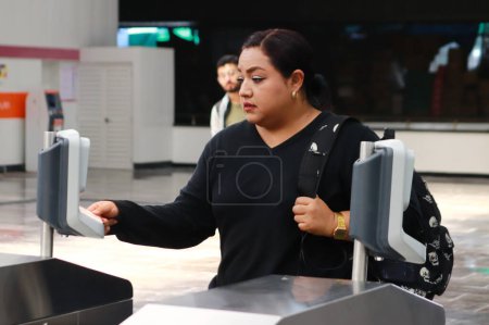 Photo for October 29, 2023 in Mexico City, Mexico:  A passenger approaches their Integrated Mobility contactless card at the card reader to acces at Mexico City Metro during the reopening of Metro Line 1 to the public after the Pantitln - Royalty Free Image