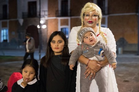 Foto de 31 de octubre de 2023, Tlaxcala, México: Miembros de la familia acompañan a sus hijos disfrazados como personajes de películas de terror para pedir dulces durante la celebración de Halloween - Imagen libre de derechos
