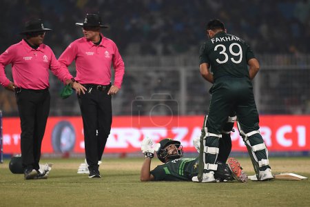Photo for October 31, 2023, Kolkata, India: Pakistan's Fakhar Zaman, helps teammate Abdullah Shafique relieve his cramp during  the match of ICC Men's Cricket World Cup  between Pakistan and Bangladesh at the Eden Gardens Stadium - Royalty Free Image
