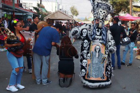 Photo for October 31, 2023 in Mexico City, Mexico: Hundreds of devotees of the 'Santa Muerte' also known as White Girl visit the altar located at Morelos colony, to celebrate the 22nd anniversary of its founding, in the brave neighborhood of Tepito - Royalty Free Image