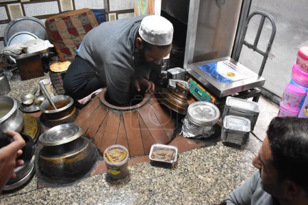 Photo for November 1, 2023, Srinagar, India: Kashmiri man cooks ''Harisa''  is a winter dish which is consumed mostly in the early mornings is a food more that over 200 years of antiquity - Royalty Free Image