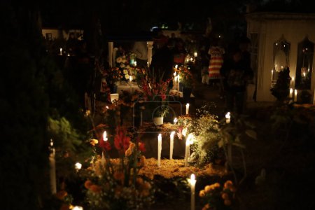 Photo for November 2, 2023, Mexico City, Mexico: Families decorate the graves of their loved ones, children and also vigil the graves of adults as part of the Day of the Dead Festival at the Pantheon of San Gregorio Atlapulco in the Xochimilco Mayor's Office - Royalty Free Image