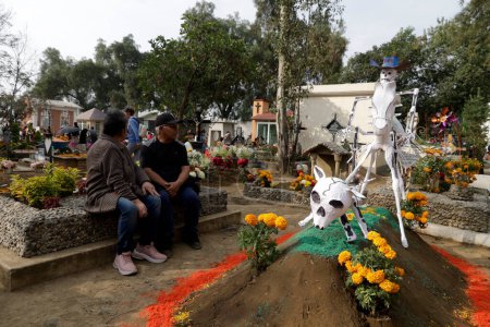 Photo for November 2, 2023, Mexico City, Mexico: Relatives decorate the graves of their loved ones with mud sculptures during the Day of the Dead festival at the Pantheon of San Antonio Tecomitl in the Milpa Alta Mayor's Office in Mexico City - Royalty Free Image