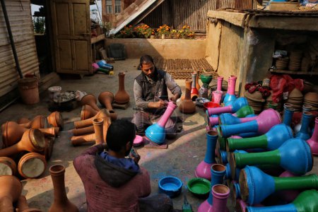 Photo for November 02,2023, Srinagar Kashmir, India : Kashmiri Muslim potters paint earthen pots ahead of the Diwali festival, on the outskirts of Srinagar. Diwali, the festival of lights symbolizes the victory of good over evil - Royalty Free Image
