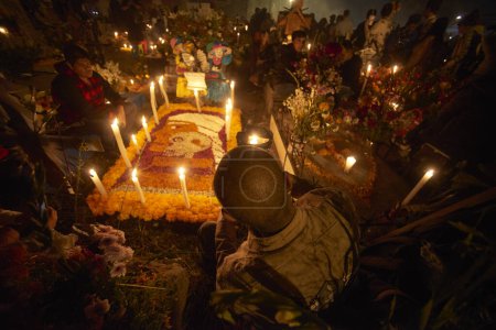 Photo for November 2, 2023, Mexico City, Mexico: Relatives decorate the tombs  with cempasuchil flowers and illuminate the tombs of their loved ones with candles, filling the pantheon with color and folklore, during the celebrations of the Day of the Dead - Royalty Free Image