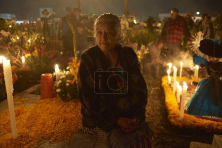 Photo for November 2, 2023, Mexico City, Mexico: Relatives decorate the tombs  with cempasuchil flowers and illuminate the tombs of their loved ones with candles, filling the pantheon with color and folklore, during the celebrations of the Day of the Dead - Royalty Free Image