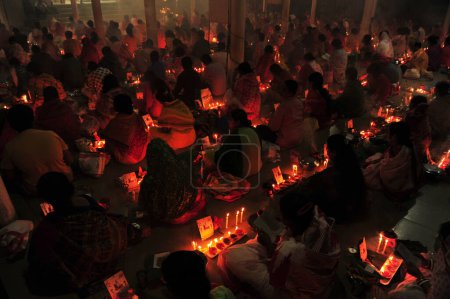 Photo for 04 November 2023 Sylhet-Bangladesh: Hindu devotees sit together on the floor of a temple to observe the Rakher Upobash festival in Loknath Temple in Sylhet, Bangladesh - Royalty Free Image