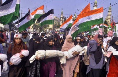 Photo for Muslim women hold model of dead child during a rally to protest against Israel attack on Gaza on November 3,2023 in Kolkata - Royalty Free Image