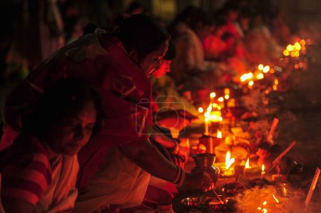 Photo for 07 November 2023 Sylhet-Bangladesh: Hindu devotees sit together on the floor of a temple to observe the Rakher Upobash festival in Loknath Temple in Sylhet, Bangladesh. Lokenath Brahmachari who is called Baba Lokenath was an 18th Century Hindu saint - Royalty Free Image
