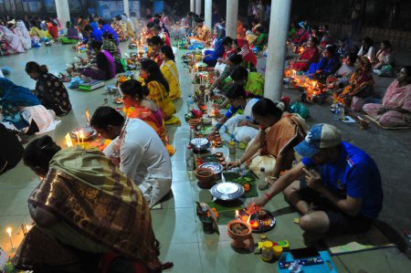 Photo for 07 November 2023 Sylhet-Bangladesh: Hindu devotees sit together on the floor of a temple to observe the Rakher Upobash festival in Loknath Temple in Sylhet, Bangladesh. Lokenath Brahmachari who is called Baba Lokenath was an 18th Century Hindu saint - Royalty Free Image