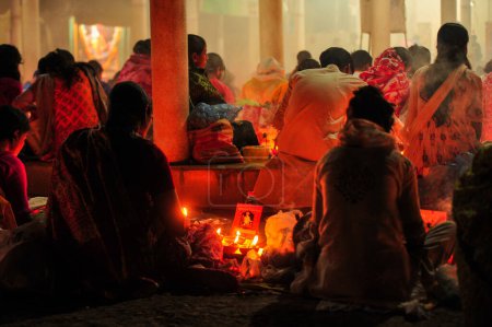 Photo for 07 November 2023 Sylhet-Bangladesh: Hindu devotees sit together on the floor of a temple to observe the Rakher Upobash festival in Loknath Temple in Sylhet, Bangladesh. Lokenath Brahmachari who is called Baba Lokenath was an 18th Century Hindu - Royalty Free Image