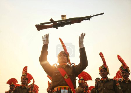 Photo for November 09,2023, Srinagar Kashmir, India : A New recruit of the Indian Border Security Force (BSF) toss his rifle to celebrate after their passing out parade in Humhama, on the outskirts of Srinagar - Royalty Free Image