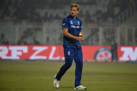 Photo for November 11, Kolkata, India: David Willey of England  tosses the ball  during the 2023 ICC Men's Cricket World Cup match between England and Pakistan at the Eden Gardens Stadium - Royalty Free Image