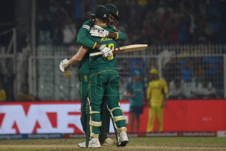 Photo for October 16, 2023, Kolkata ,India: David Miller  of South Africa celebrates his century as Kagiso Rabada watches during the semifinal match between Australia and South Africa of the ICC Men's Cricket World Cup at Eden Gardens Stadium - Royalty Free Image