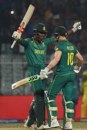 Photo for October 16, 2023, Kolkata ,India: David Miller  of South Africa celebrates his century as Kagiso Rabada watches during the semifinal match between Australia and South Africa of the ICC Men's Cricket World Cup at Eden Gardens Stadium - Royalty Free Image