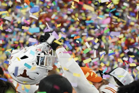 Photo for December 2, 2023, Arlington, Texas, United States: Texas Longhorns player's helmet and confetti.   2023 Dr Pepper Big 12 Championship game between Texas and Oklahoma State - Royalty Free Image
