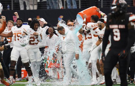 Photo for December 2, 2023, Arlington, Texas, United States: Texas Longhorns t head coach Steve Sarkisian receives a Gatorade shower after the conclusion of the 2023 Dr Pepper Big 12 Championship game between Texas Longhorns and Oklahoma State Cowboys - Royalty Free Image