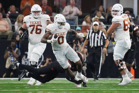 Photo for December 2, 2023, Arlington, Texas, United States: Texas Longhorns   tight end Ja'Tavion Sanders is tripped by a Oklahoma State player during the 2023 Dr Pepper Big 12 Championship game between Texas Longhorns - Royalty Free Image